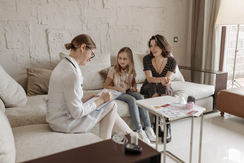 Doctor consulting with a mother and daughter at a San Antonio clinic — get free help applying for Texas Medicaid