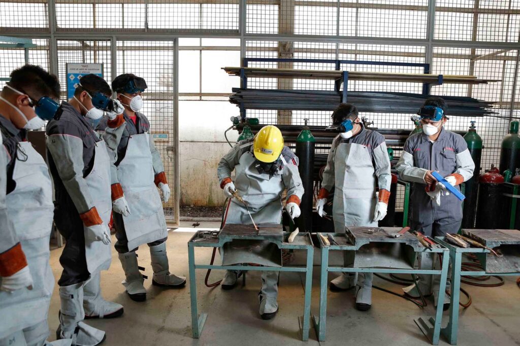 Workers in protective gear during free job training in San Antonio — welding and skilled trades cert